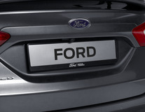 Ford License Plate Holder nero, con logo Ford ovale blu e scritta "BRING ON TOMORROW" bianca